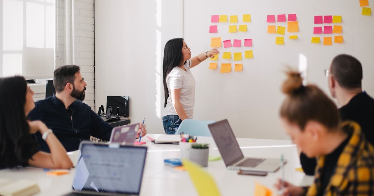 Manager reviewing work with team member at a desk