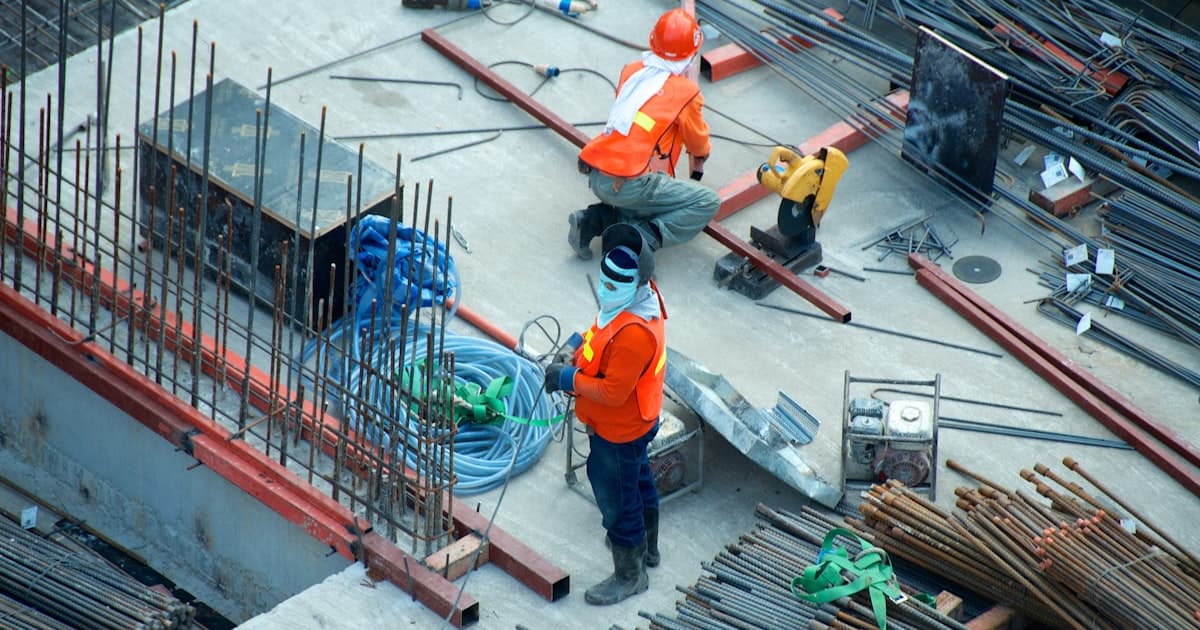 Field worker reviewing work on a mobile phone at a job site